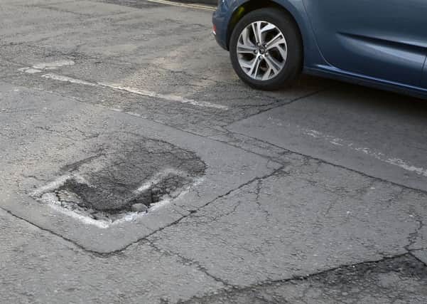 Potholes can occur after a road has been dug up by a utility firm (Picture: Neil Hanna)