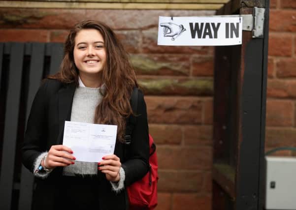 Schoolgirl Ivy Hare, 17, a resident of Edinburgh but from Orange County, California, proudly shows off her polling card before  voting in the Scottish independence referendum (Picture: Getty)