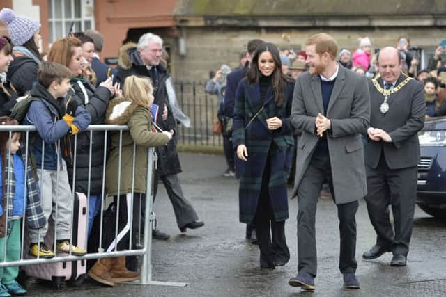 Prince Harry and Meghan Markle are accommpanied by the Lord Provost during a walkabout on the esplanade at Edinburgh Castle. Picture: John Linton/PA Wire