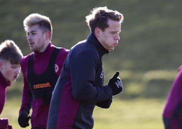 Christophe Berra feels the cold as he trains for the Ross County game at Riccarton