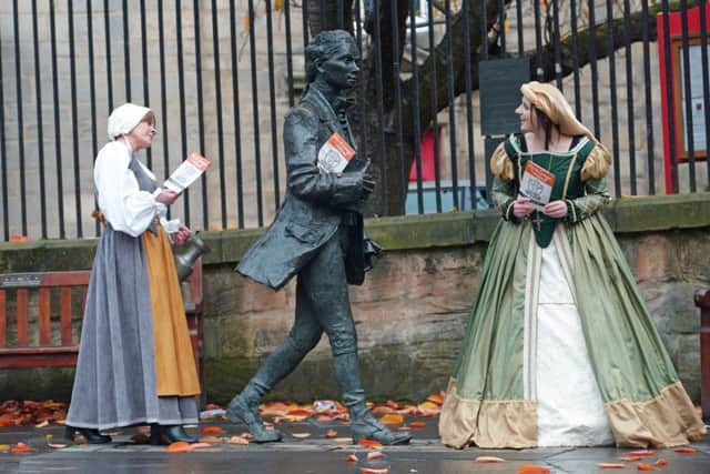 Actors from Mercat Tours with the statue of Scottish poet Robert Feruson