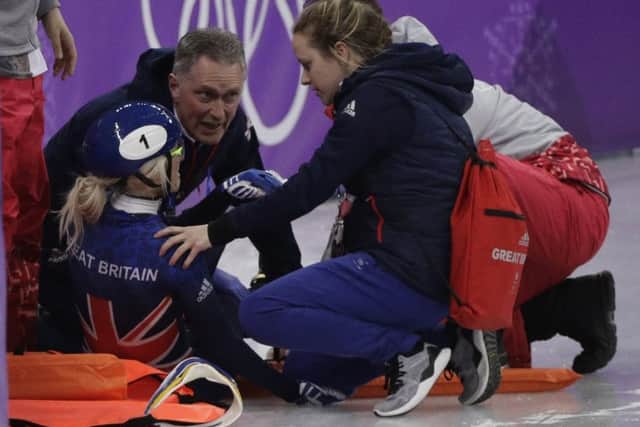 Elise Christie of Britain is attended to after crashing during her women's 1500 meters short track speedskating semifinal in the Winter Olympics. Picture; AP