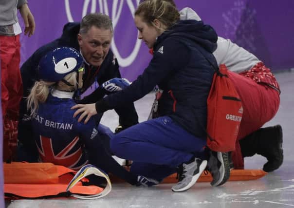 Elise Christie of Britain is attended to after crashing during her women's 1500 meters short track speedskating semifinal in the Winter Olympics. Picture; AP