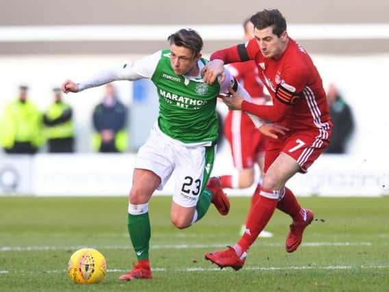 Hibs Scott Allan battles with Aberdeen's Kenny McLean for possession at Easter Road this afternoon
