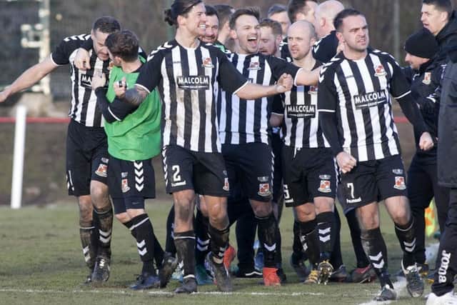 The Beith players celebrate their late winning goal