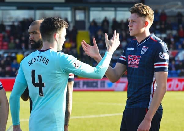 Brothers John Souttar, left, and Harry Souttar shake hands before the start of Hearts v Ross County. Pic: SNS