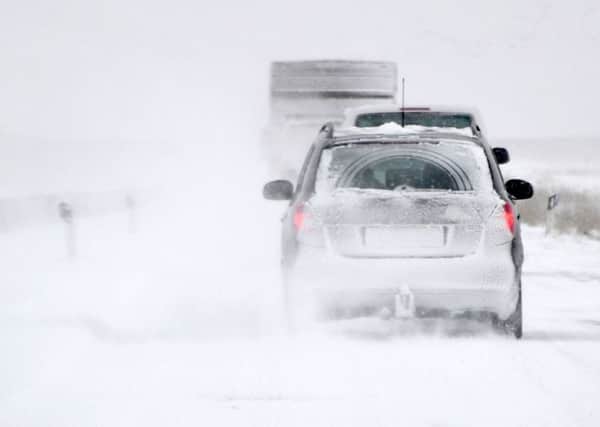 Take a blanket, warm clothes, water and food when driving in snow (Picture: AFP/Getty)
