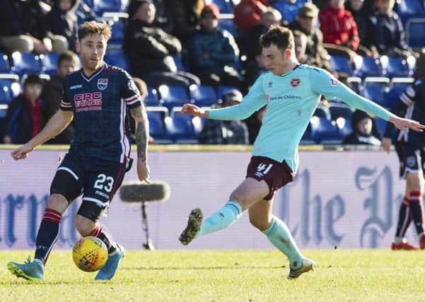 Ross County's Greg Tansey, left,  in action with Hearts' Andy Irving