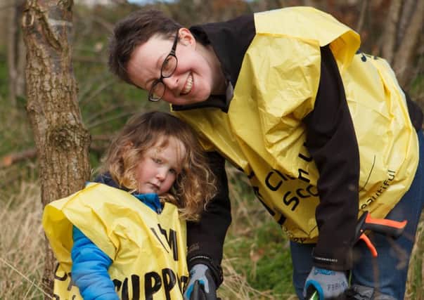 Karen Sales and young Isabel take part in a previous Burdiehouse Burn clean-up. Picture: Toby Williams