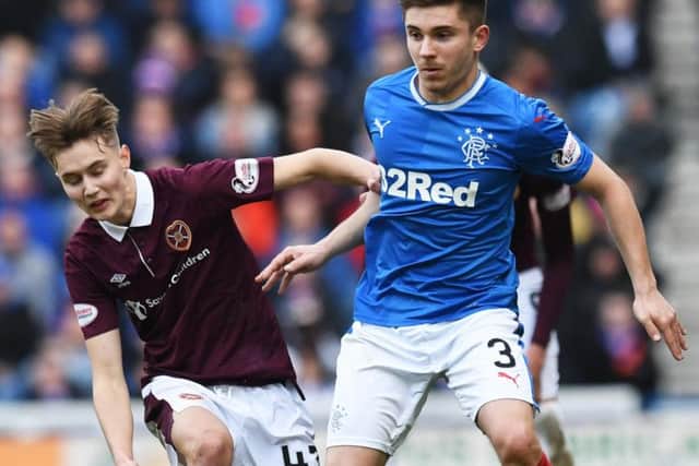 Hearts midfielder Harry Cochrane with Rangers defender Declan John during the match at Ibrox