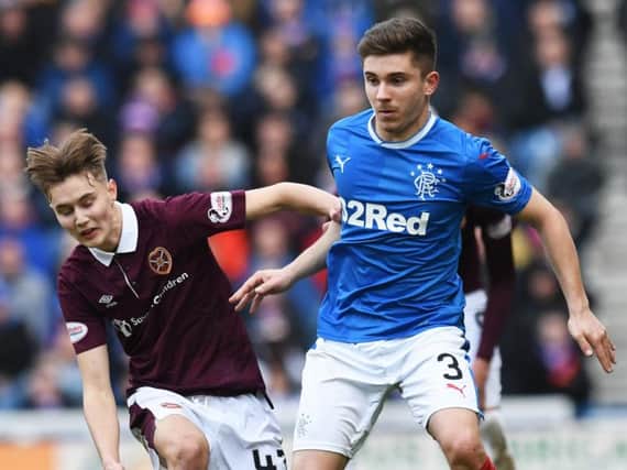 Hearts midfielder Harry Cochrane with Rangers defender Declan John during the match at Ibrox