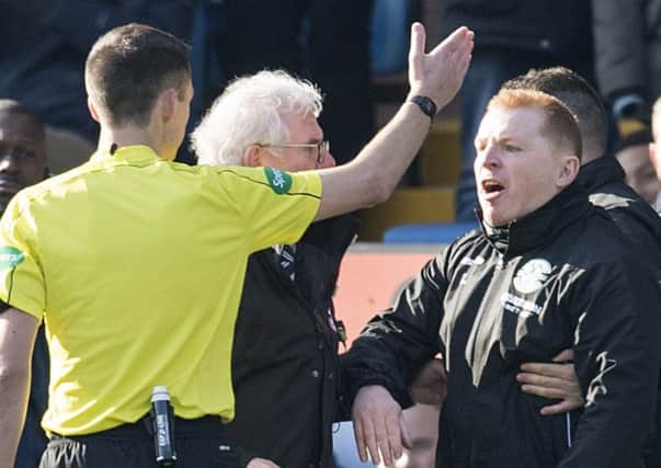 Neil Lennon exchanges words with referee Kevin Clancy