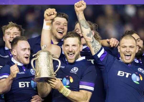 John Barclay shows off the Calcutta Cup after Scotlands win over England to the delight of his team-mates