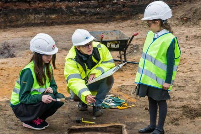 Amelia Soffe, five, Lousie Doyle, ten, and archaeologist Megan Stoakley at the site, Picture: Ian Georgeson