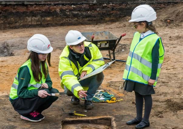 Amelia Soffe, five, Lousie Doyle, ten, and archaeologist Megan Stoakley at the site, Picture: Ian Georgeson