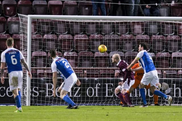 Steven Naismith stoops to score his first goal for Hearts. Pic: SNS