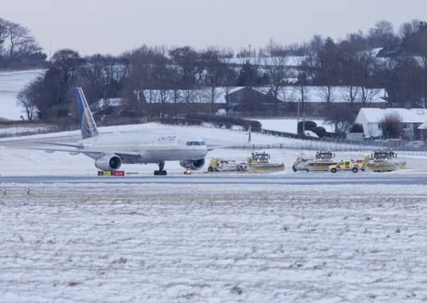 Gritters try to keep runways clear from heavy snow at Edinburgh Airport.