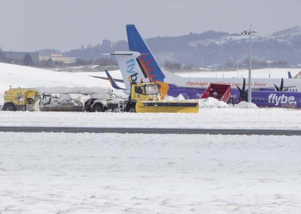The ground staff at the airport have been working hard with snow ploughs to keep the runways clear. Picture: SWNS