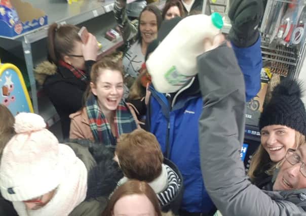 Delighted locals getting milk at Waz's in Broxburn. Picture: Scott Mooney