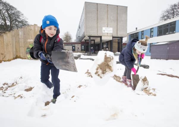 Finlay Johnston,8 and Molly Walsh, 8, help out with the snow clearing party at Trinity Primary School, Edinburgh.