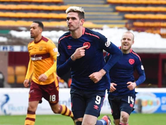 Kyle Lafferty sets off to celebrate after equalising for Hearts against Motherwell