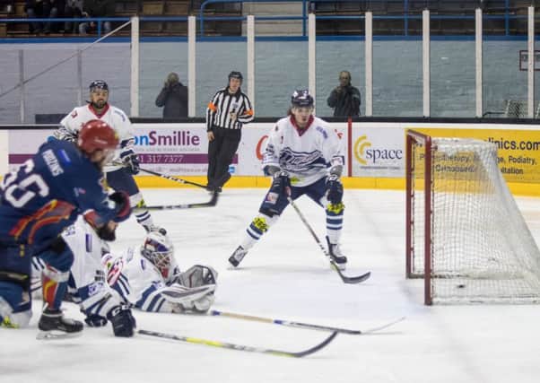 Ainars Podzins sends the puck past the sprawling Dundee netminder Travis Fullerton. Pic: Ian Coyle