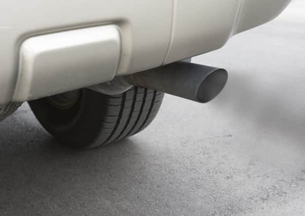 A car emitts carbon monoxide gas from its exhaust tailpipe, showing how pollution is formed.