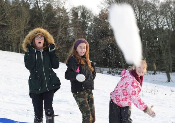 Martha Beattie, Eilish Dodd and Sophie Scott taking time out from sledging at Duns Castle to trhow some snowballs at our photographer