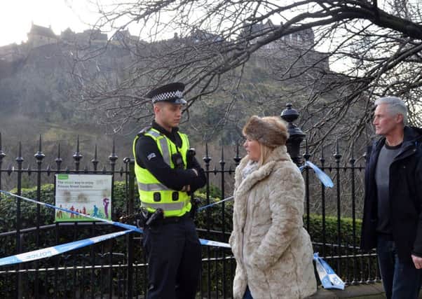 Police stand guard after the discovery of a suspicious device in Princes St Gardens. Pic: Jon Savage