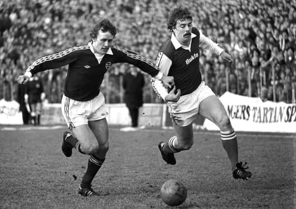 Hearts' Walter Kidd, left, challenges for the ball with Tony Higgins