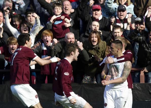 Suso Santana, right, celebrates scoring his goal in the 94th minute with team-mates and fans at Tynecastle