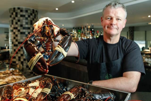 Roy Brett with some of the Lobsters he serves. Picture: Toby Williams