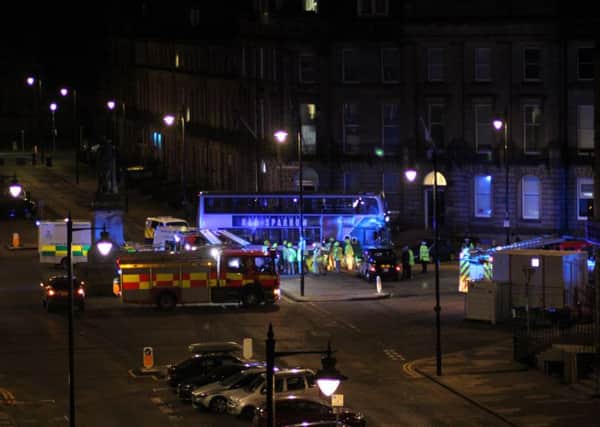 Emergency services at the scene to remove a 68-year-old woman from underneath the bus. Picture by Andy Quinn