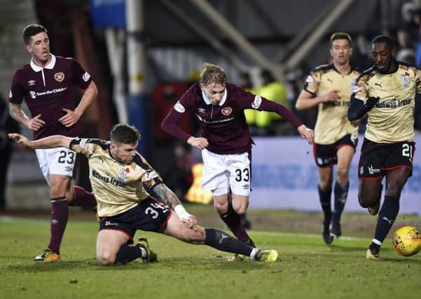 Lewis Moore, pictured playing against Dundee earlier in the season, wants to get the winning habit back after defeat by Hibs in the Edinburgh derby last week. Pic: SNS