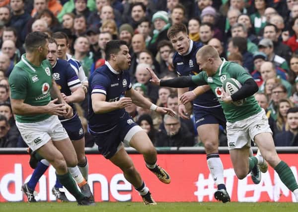 Ireland's Keith Earls prepares to hand off Scotland's Sean Maitland.
 Pic: Ian Rutherford