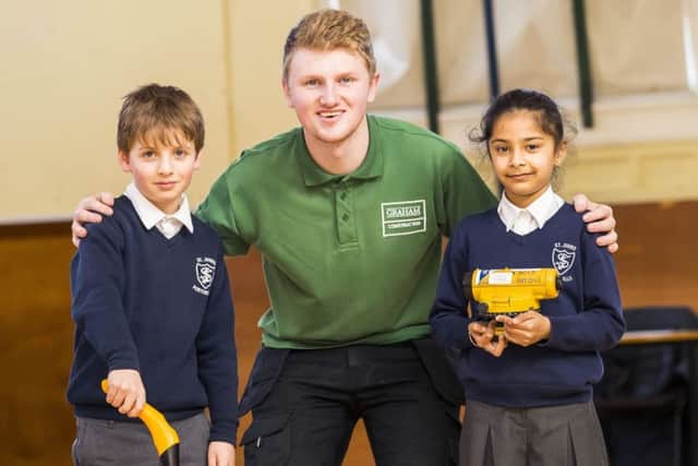 project: Apprentice site manager Greg Wilkinson gives eight-year-old pupils Leandro Forno and Ria Kaur an insight into his work