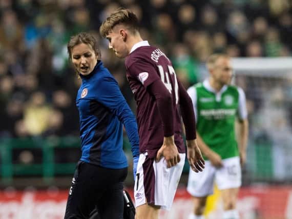 Harry Cochrane trudges off after treatment from the Hearts physio at Easter Road