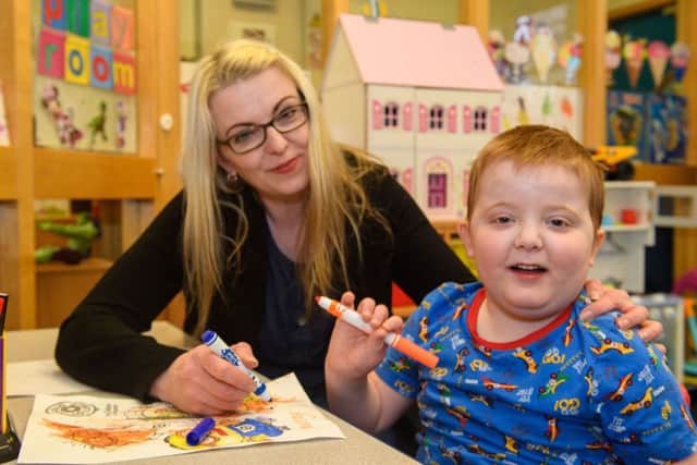 Karen Gray with son Murray, who is in hospital due to his seizures, Picture: Ian Georgeson