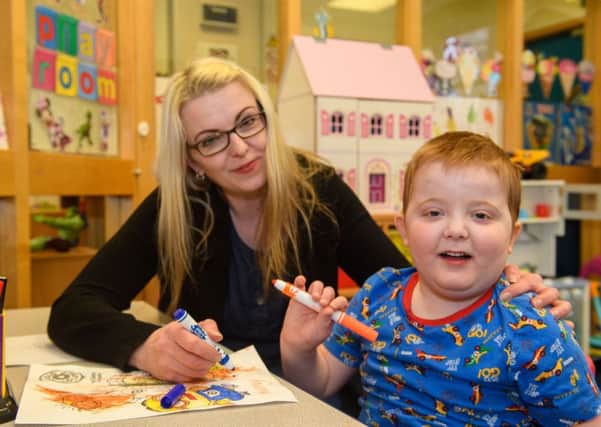 Karen Gray with son Murray, who is in hospital due to his seizures, Picture: Ian Georgeson