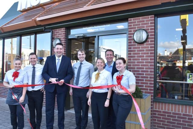 Miles Briggs joins Cameron Fraser and staff to cut the ribbon at a refurbished McDonald's/