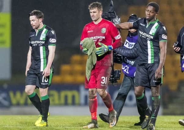 Cammy Bell leaves the pitch, congratulated by Marvin Bartley, after ensuring Hibs left Perth with a point