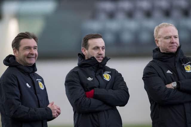 Scotland coach Peter Grant, left, runs the rule over the squad alongside James McFadden, centre, and Alex McLeish. Pic: SNS