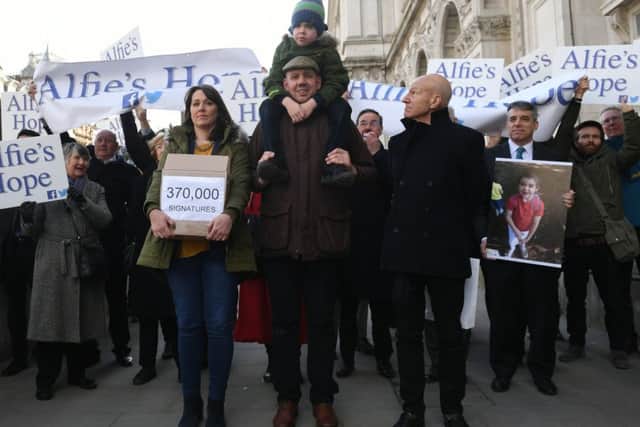Six-year-old Alfie Dingley, his parents Drew Dingley and Hannah Deacon and actor Sir Patrick Stewart on Whitehall in London before handing in a petition to No 10 Downing Street asking for Alfie to be given medicinal cannabis to treat his epilepsy. Picture: PA