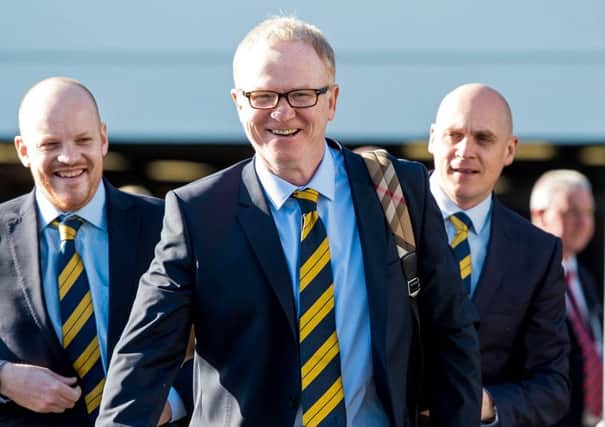 Scotland manager Alex Mcleish was all smiles as he prepared to jet to Hungary from Edinburgh Airport
