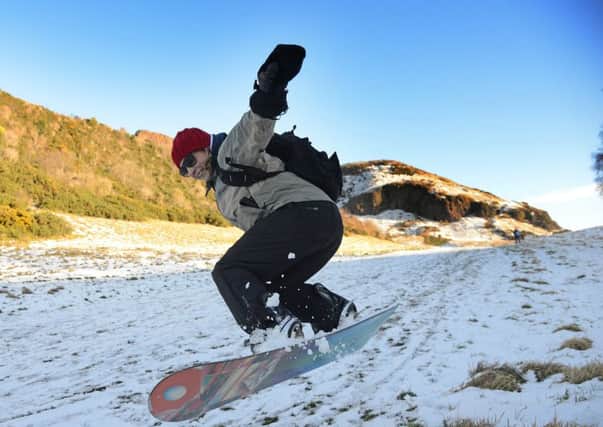 Deborah Bowie takes advantage of the snow in Holyrood Park to do some snowboarding