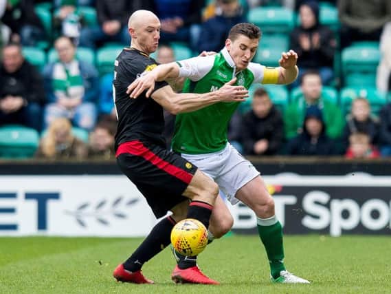 Hibs skipper Paul Hanlon battles with Partick striker Conor Sammon for possession at Easter Road this afternoon