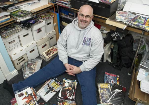 Edinburgh Comic Con organiser Jamie Lundy with some of his comic collection