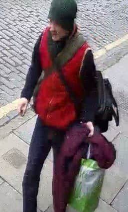This woman carrying a maroon-coloured blanket or jacket is also being sought in connection with the Canongate fire