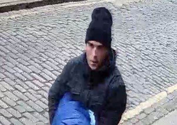 Police are searching for this man, who is pictured wearing dark clothing, a black beanie hat, dark-coloured Nike trainers and in possession of a blue blanket or sleeping bag