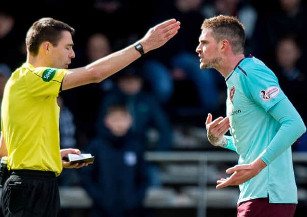 Referee Kevin Clancy booked Kyle Lafferty after the Northern Irish striker went down under a challenge from Dundee defender Steven Caulker. Picture: SNS Group